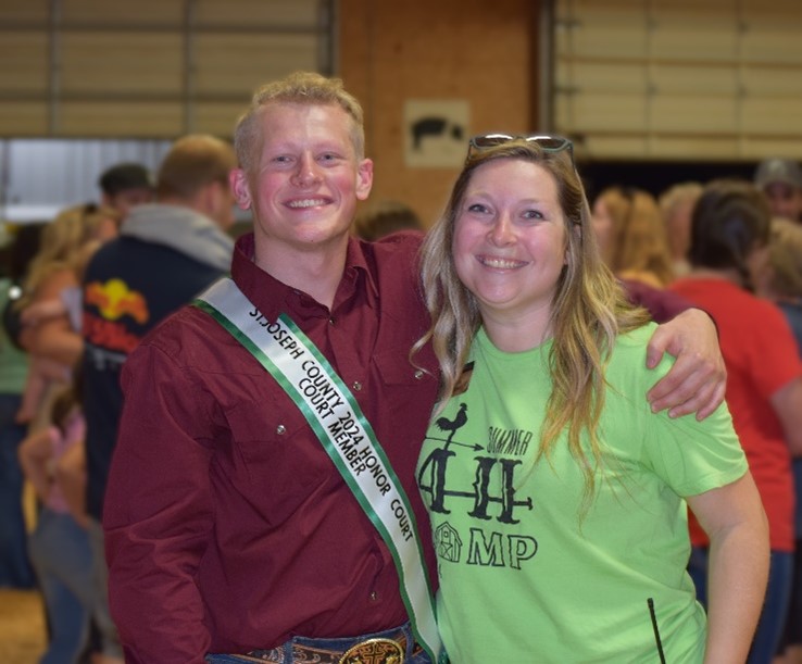 A young blond man standing next to a blond woman.